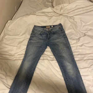 Blå jeans från Diesel - Snygga blå jeans från Diesel med en klassisk femficksdesign. Jeansen har en lätt tvättad look och raka ben. Perfekta för en avslappnad stil.
