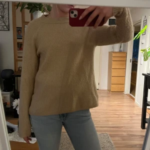 Beige stickad tröja - Säljer en mysig beige stickad tröja med långa ärmar. Perfekt för kyligare dagar och enkel att matcha med jeans eller kjol. Tröjan har en rund halsringning och en avslappnad passform.