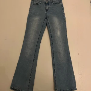 Blå jeans från UNIQ - Säljer ett par klassiska blå jeans från UNIQ. De har en bootcut-stil och är tillverkade i denim. Perfekta för en avslappnad look. Med resår i midjan. Dem är low- mid weist. Pris går att diskutera!