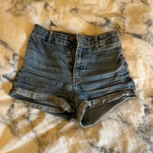 Blå jeansshorts - Snygga blå jeansshorts med hög midja, uppvikta ben och stretchiga. Använda mycket men nu försmå💕