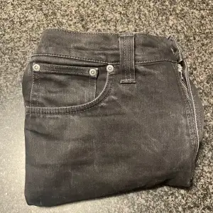 Säljer ett par snygga grå jeans från Nudie Jeans i storlek 32/34. De är tillverkade av 100% ekologisk bomull och har en klassisk design med dragkedja och knapp. Mycket sköna och bra passform. Nypris cirka 2000, mitt pris 900. Knappt använda och priset är inte hugget i sten! Bara att fråga vid minsta fundering. Går att lösa bilder när plagget sitter på också👍