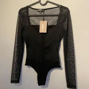 Body från missguided. Säljer då jag inte såg att det var en body när jag köpte den. Oanvänd. Jag skulle säga armarna är lite kortare men jag är närmare 170cm så kan bero på det! Man knäpper ihop den där fram som en bh ungefär. 