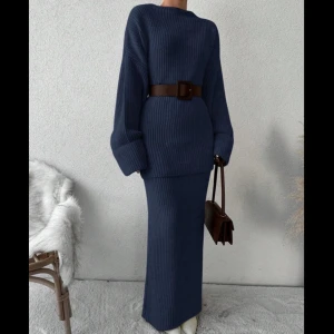 Mörkblå stickad klänning - Säljer en superfin mörkblå stickad sett som är perfekt för höst och vinter. Den har en lång och elegant passform. Settet är i långa ärmar och är gjord i ett mjukt och bekvämt material. 