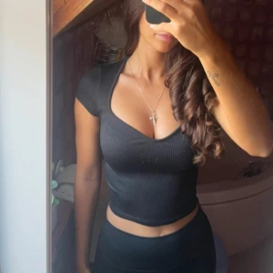 Svart populär gina topp - En ribbad topp från gina tricot. Är i storlek XS. Är superfin och är stretch. Är oanvänd och bara ligger hemma. Köparen står för frakten ❤️