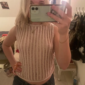 Beige ribbad ärmlös topp  - Säljer en söt beige ärmlös topp med ribbat mönster.     Toppen har en snygg detalj med knytning på båda sidor. Perfekt för varma dagar då den också är genomskinlig. Aldrig använd🫶🫶