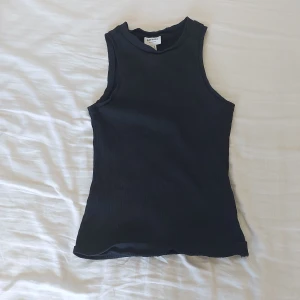 Svart ärmlös topp från Vero Moda - Säljer en svart ärmlös topp från Vero Moda. Den är i storlek XS och är perfekt för sommaren. Toppen är tight och tillverkad i ett mjukt och bekvämt material. Den har en enkel och stilren design. Nyckick🖤🩶