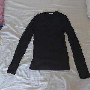 Svart långärmad tröja från Gina Tricot - Säljer en svart långärmad tröja från Gina Tricot, basically basics kollektionen. Tröjan är i storlek S och är perfekt för höst och vinter. Den är gjord av ett mjukt och bekvämt material, vilket gör den idealisk för vardagsbruk. Passformen är normal och den är enkel att matcha med olika outfits. Perfekt basplagg att ha i garderoben! Den är i nyskick, väldigt lite använd🖤