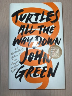 Turtles All The Way Down - Romanen 'Turtles All The Way Down' av John Green har ett vitt omslag med en stor orange spiral och svart handskriven text. Boken är en specialutgåva med en limited edition-jacka och poster. Perfekt för dig som gillar ungdomslitteratur och samtida berättelser. Språk: Engelska