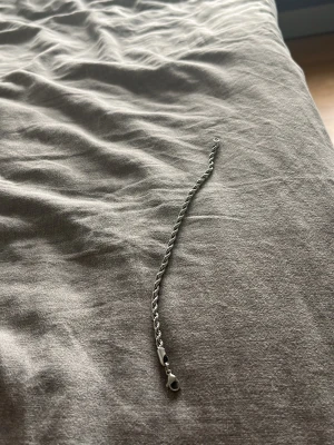 Silverfärgat kedjearmband - Snyggt och stilrent armband i silverfärg med kedjedesign. Armbandet har en klassisk karbinhake som lås och passar perfekt för dig som gillar minimalistiska accessoarer. Materialet ser ut att vara metall och armbandet har en enkel men trendig look. Rostfri✌️