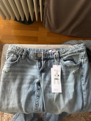 Ljusblå ripped jeans med raka ben - Lågmidjade jeans med hål, från gina young 14+. Helt nya