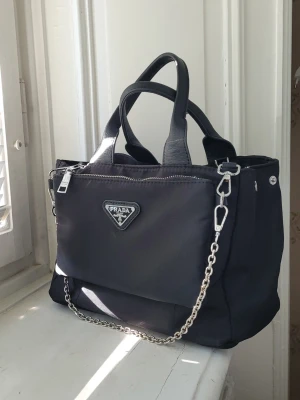 Svart handväska axelväska axelremsväska crossbody 2 in 1  - En supersnygg nylon väska som kan användas på flera olika vis, som axelväska, handväska eller crossbody, går att ta av delarna. 
