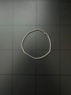 Silverfärgat kedjearmband - Snyggt armband i silverfärgad metall med rundade länkar som ger en stilren och modern look. Armbandet har ett klassiskt lås och passar perfekt för dig som gillar minimalistiska accessoarer. Längden är cirka 20 cm.