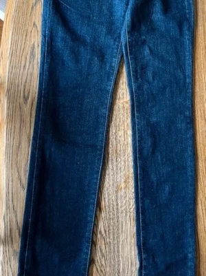 Levis / Levis jeans / jeans / byxor / kläder - Säljer ett par mörkblå jeans med rak passform och klassisk femficksdesign. Jeansen har en tidlös look och är tillverkade i denim med lätt stretch för extra komfort. Perfekta till en avslappnad stil och passar till det mesta i garderoben.