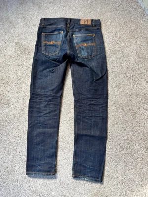Nudie selvage jeans - Feta selvage jeans från Nudie i modellen ”Gritty Jackson”. Har använt de i några månader så har lyckats fadea de lite men finns mer att jobba på! Det finns två små hål i ena fickan men märks ej vid användning och går att laga väldigt lätt. Kan mäta jeansen ifall det skulle önskas. Vid andra funderingar tveka ej att höra av sig😁