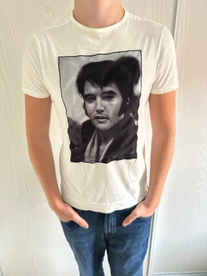 Vit Limitato T-shirt  - Vit Limitato T-shirt Storlek: S Användning: bra skick, jätte litet på på ena axeln hål(se sista bild) Nypris: 1800 SEK  Passform: Normal Modellen på bilden: 184 CM 77 KG Artist: Terry O’neill | Print: Elvis Presley | Namn: Suspicious Minds Skickas inom 24h😁