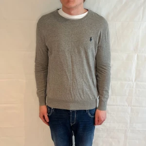 Polo Ralph Lauren Slim Fit Sweater Grey Men's - Begagnad grå stickad tröja i slim fit från Ralph Lauren. Storlek M, etiketten är något skadad.