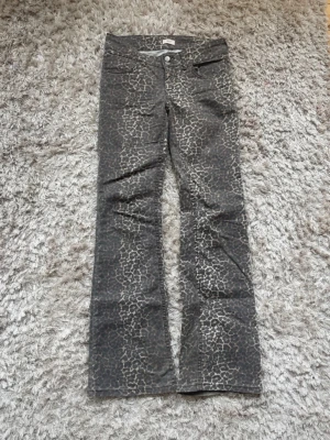 Leopardmönstrade jeans från Nelly - Säljer ett par snygga leopardmönstrade jeans från Nelly. Jeansen har bootcut-modell, normalhög midja och klassisk femficksdesign. Färgen är brun med beigea inslag och materialet känns mjukt och stretchigt. Perfekta för dig som vill sticka ut lite extra!