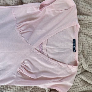 Rosa topp - Söt, rosa topp med detaljer! Materialet är fantastiskt skönt. Färgen är en mer varm rosa än vad som syns på bilderna. Står M/L i etiketten men är snarare en S/M. Skriv gärna i DM vid frågor 💗