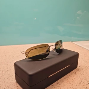 Giorgio Armani sunglasses  - Giorgio Armani, ltaly 1551 1144/6E. SUNGLASSES 57-17-120 Rimless Gunmetal frame Giorgio Armani, ltaly 1551 1144/6E Sunglasses Rimless frame with gunmetal connections and arms. Marked measurements of 57-17-120. In good preowned condition.