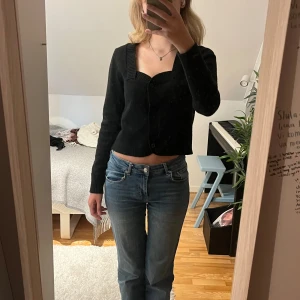 Svart tjockare kofta - Svart kofta med en superfin urringning. Funkar både att ha för sig självt men även över ett tunnare plagg. Enbart använt ett fåtal gånger. Normal i storleken. Mycket bra skick.