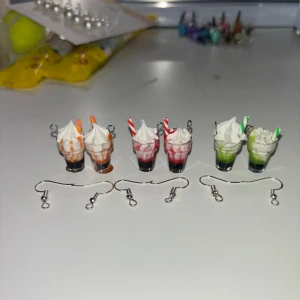 Milkshake berlock som örhängen - Dessa är örhängen som jag gör själv. Ni bestämmer själva vilken färger ni vill ha. Men det finns bara de färger som är med på bilderna. Dessa är aldrig använda. Skriv till mig om du undrar något. OBS! När du köper denna kommer du endast köpa ett par!