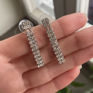 Silvriga örhängen  - Silvriga örhängen. Baksidor något slitna, syns på bilderna.