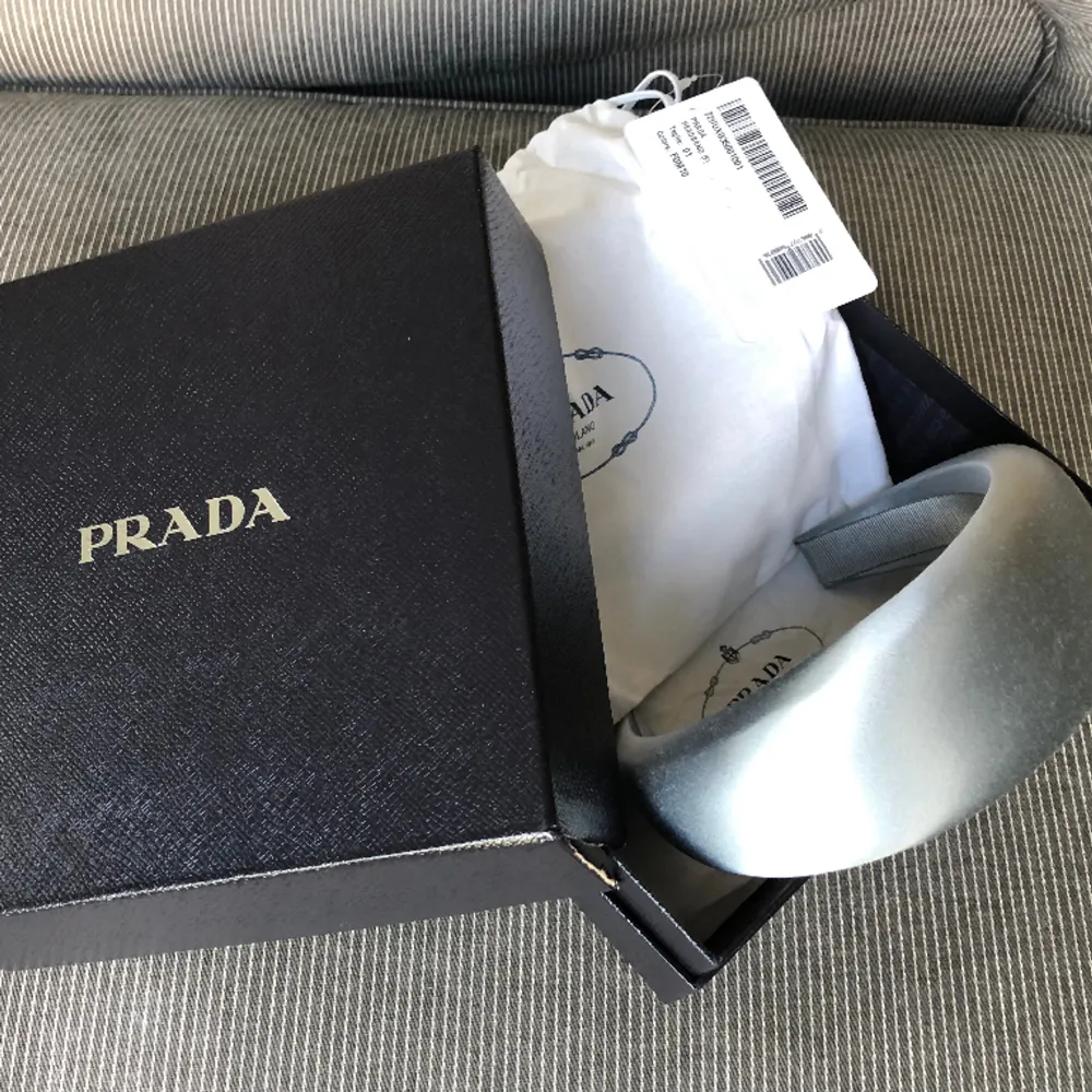 Nytt Daidem från Prada i vacker ljus gråblå färg. Aldrig använt. Dustbag, box och kvitto medföljer.. Accessoarer.