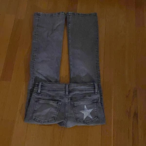 Lågmidjade jeans - Lågmidjade jeans från Gina Tricot. Gråa med en stjärna på högra fickan. Helt nya och bara testade. De passade inte mig och det är därför jag säljer dem! 