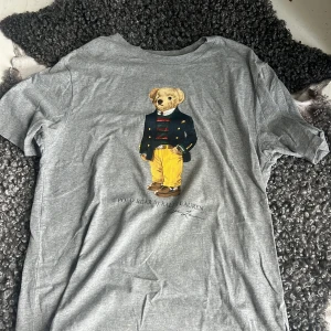  Ralph lauren bear t-shirt  - Okej skick, ganska använd. Tröjan itter som en medium men är den är i XL fast i barn storlek