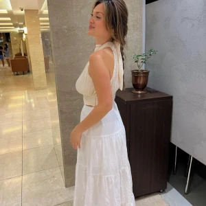 Topp - Endast använd en gång så som ny! Öppen rygg med fin snörning i nacken. 