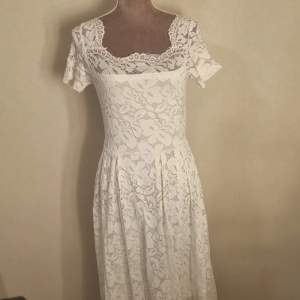 En vit klänning med spets mönster. Säljer för att den inte kommer till användning längre 