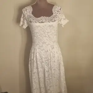 En vit klänning med spets mönster. Säljer för att den inte kommer till användning längre 