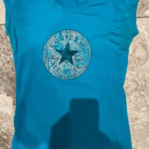Neon blå stark färgad Converse t-shirt. Säljs i befintligt skick, kan förekomma små fläckar vid armhålan. Väldigt mjuk och bekväm.Säljer pga stor garderobrensning. Kika gärna på mina andra annonser, säljer mycket. Samfraktar gärna:) 