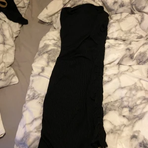 Klänning  - Svart klänning med snören som man kan dra åt på Böda sidorna❣️