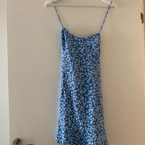 Blommig klänning - Blå blommigklänning med korsad rygg