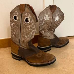 Superfina cowboy-boots i äkta läder 🤠👢👢🐎 Storlek 39. Några trådar har släppt vid de runda hålen (vilket nig lätt kan fixas om en vill det), annars i gott skick då skorna är sparsamt använda ✨