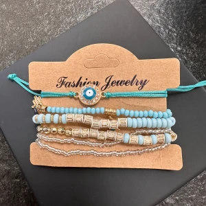  Trendy Boho Evil Eye Bracelet Set -  Trendy Boho Evil Eye Bracelet Set Accessorize in style with this trendy boho evil eye bracelet set. Featuring a mix of vibrant turquoise beads, gold-tone charms, and the iconic evil eye symbol, this set is perfect for add