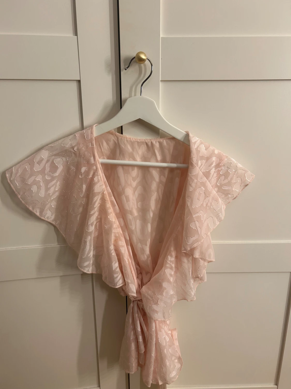 Ljusrosa blus med volangärm