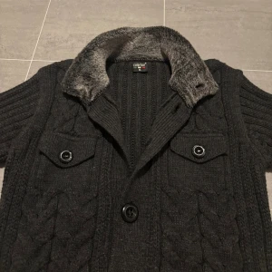 Knitted cardigan med pälskrage - Säljer en sjukt snygg cardigan med pälskrage som passar perfekt nu vid kyligare tider. Skicket är bra men enda defekten är att det saknas en knapp som man ser på sista bilden (inget som stört mig under användning då jag alltid har den uppknäppt ändå. Storleken är XL i barnstorlek men sitter som en S. Passar dig mellan 170-178 ungefär. Priset kan diskuteras!