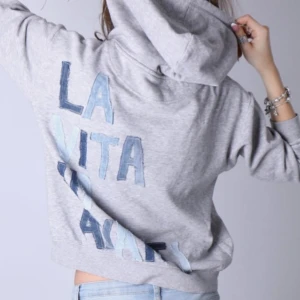 Unik grå hoodie med jeans text på ryggen  - Otroligt fin och unik hoodie med jeans detaljer på ryggen. Texten som står på ryggen är ”LA VITA VA AVANTI”!!  - Storlek: S - Modellen är 175 cm för referens och bär vanligtvis XS-S!!  Hoodien är i jättebra skick och har inga defekter (vad vi märkt)!!  Vid frågor eller funderingar - tveka inte att höra av dig🪽 