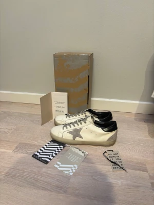 Golden Goose skor, stolek 43 - Riktigt feta Golden goose i storlek 43, true to size. Klassiska vit och gråa färgen. Skorna är i nästan ny skick finns inga skavanker på skorna. Skor och box medföljer.   Prisförslag tas emot men inga skambud!   Frågor så bara kontakta, snabba svar utlovas!