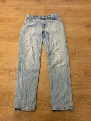 Ljusblå Raka Jeans - NYPRIS: 400kr  Säljer ett par ljusblå jeans med rak passform och klassisk femficksdesign. Jeansen har en enkel look utan slitningar eller dekorationer, perfekta till vardags. Tillverkade i mjukt denimtyg för skön känsla.