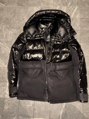 Moose knuckles Duglad jacka - Säljer en svart dunjacka som köptes på johnells 2 år sedan. Sparsamt använt jacka har inga repor eller skador. Kan mötas i stockholm eller frakt SIZE M