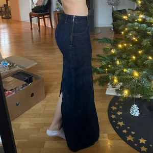 Mörkblå lång jeanskjol från Zara - En lågmidjad mörkblå jeans-kjol, med dragkedja vid vänster sida. Slit i bak🫶 maxi