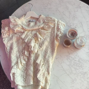 Vit spetsblus med volanger från Zara - Supersöt vit/beige blus från Zara med spets och volangdetaljer framtill och vid axlarna. Tröjan äe helt slutsåld💞skriv via funderingar & frågor 