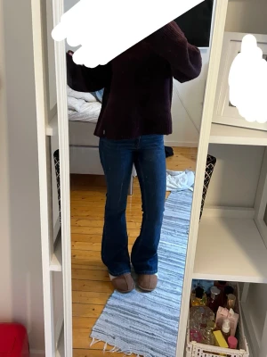 Blå bootcut jeans med låg midja - Snygga blå bootcut jeans med låg midja och klassisk femficksdesign. Jeansen har en tidlös passform som sitter skönt över höfterna och släpper ut vid benen. Perfekta till både sneakers och boots.