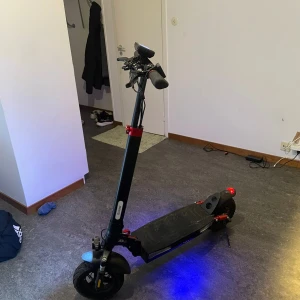 Elscooter - Kraftfull elscooter med stora däck, LED-belysning och robust ram. Utrustad med display på styret och skivbromsar. Synligt bruksslitage på fotplattan men i gott skick. Perfekt för stadspendling och fritid. Hastigheten är 40km/h Stad: Linköping 