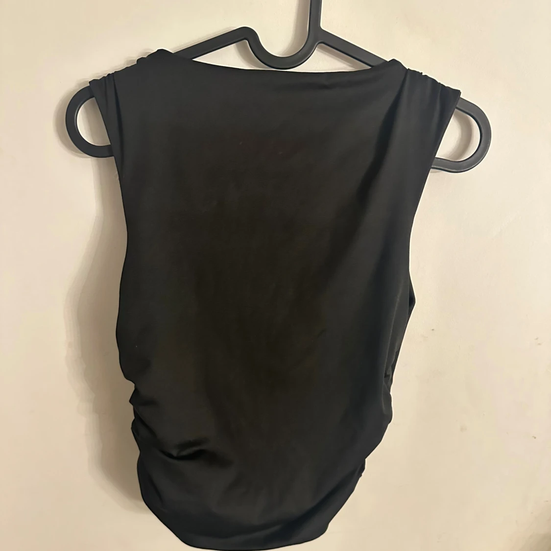 Svart ärmlös topp med rynkade sidor - 1