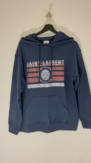 Saint Laurent Hoodie - Gott skick, storlek M sitter som S hade jag sagt. Först till kvarn på denna, meddela mig vid fler frågor eller funderingar. Priset är ej hugget i sten 