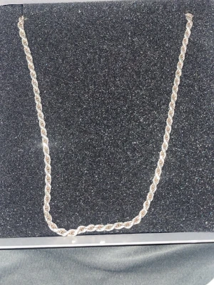Silverfärgad kedja i äkta 925 silver - Säljer en snygg silverfärgad kedja i äkta 925 silver med tvinnad design. Kedjan har en robust karbinlås och passar perfekt som halsband. Stilren och enkel att matcha med olika outfits. Perfekt för dig som gillar klassiska smycken med lite extra glans. Priset kan sänkas! 